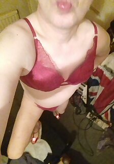 Fully shaven Holly in lacy red bra and panties and 5 inch red stripper heels.