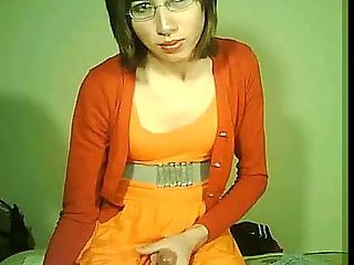 Lonely tranny in orange jerks for webcam