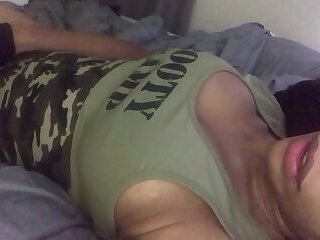 Laying in bed stroking her big cock in a camouflage outfit and busting a nut